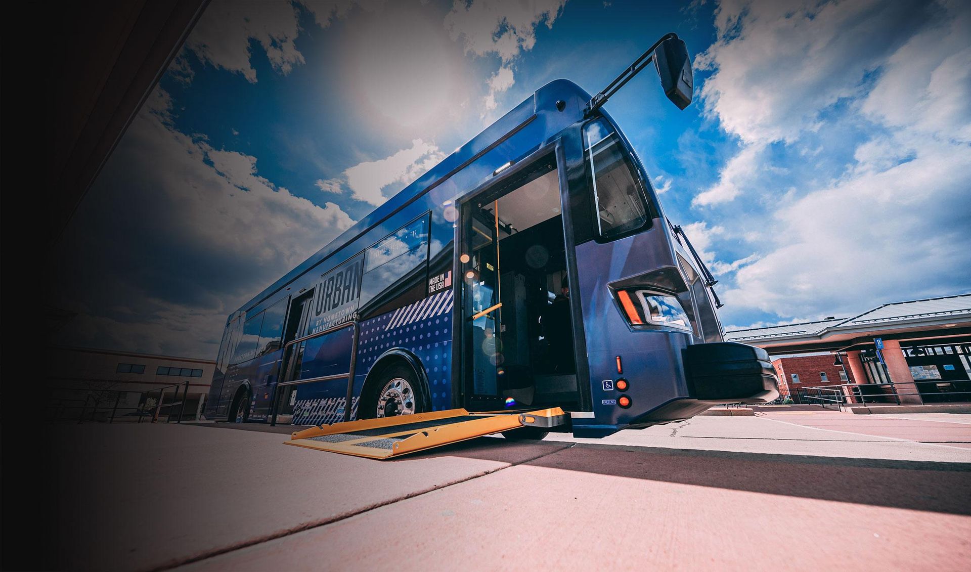 City transit bus boarding passengers – HMFG transit platform